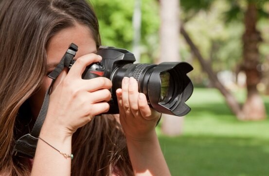 Fotografė dirba su fotoaparatu – tinklapių kūrimas kūrėjams be techninių kliūčių